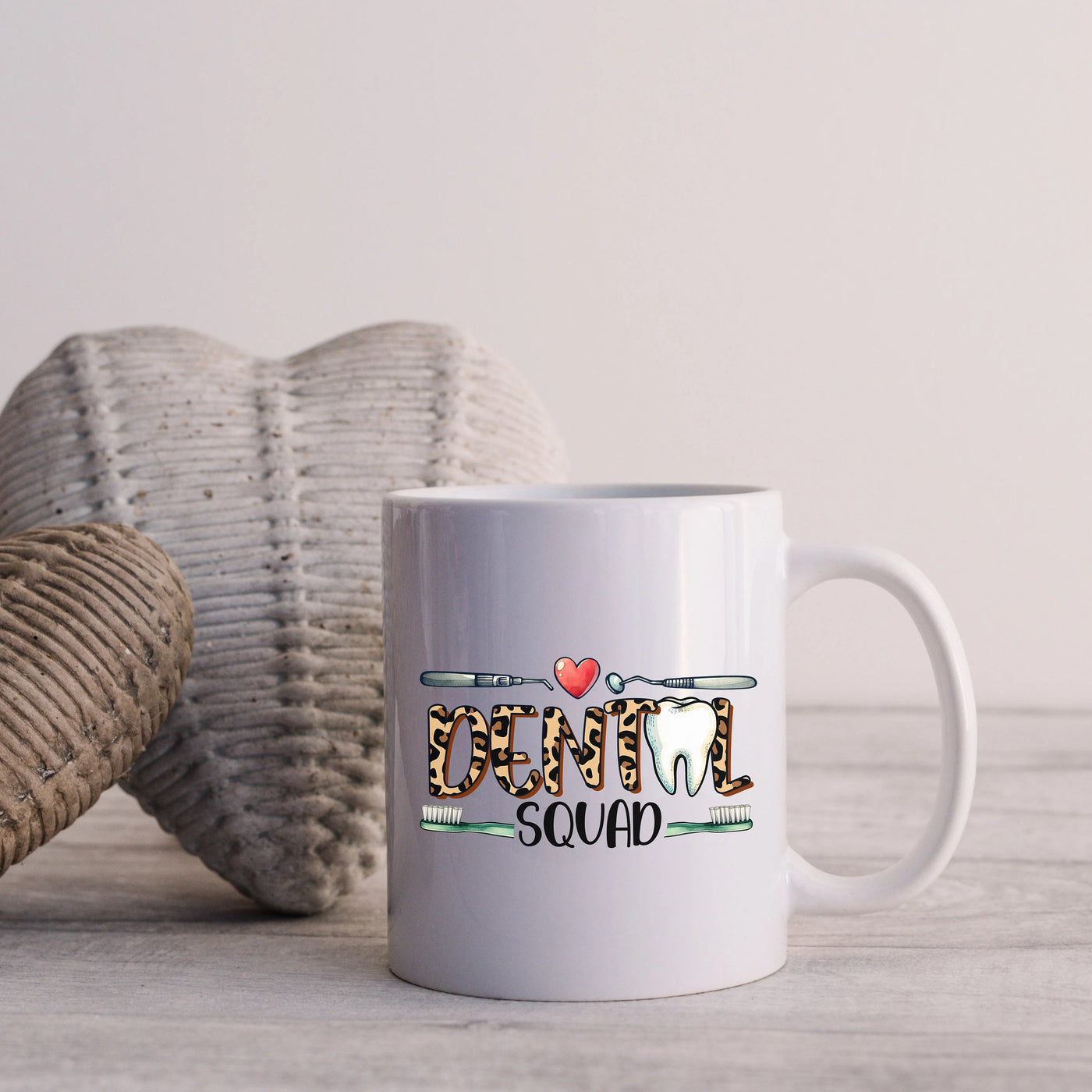 a white coffee mug sitting on top of a wooden table