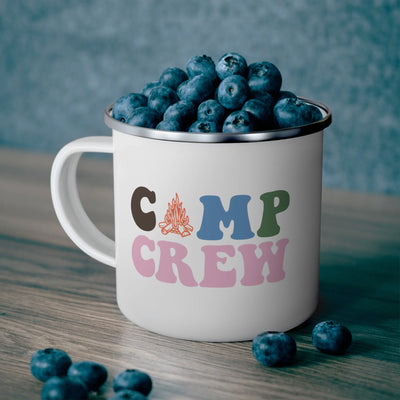 a white coffee cup filled with blueberries on top of a wooden table