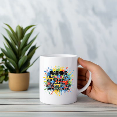 a person holding a white coffee mug with the words warning on it