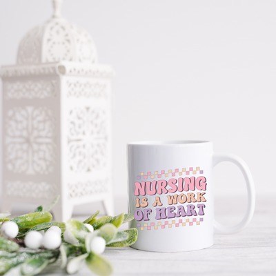 a white coffee mug with the words nursing is a work of heart