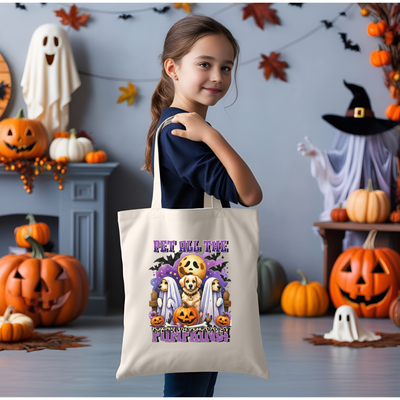 a little girl holding a trick or treat bag