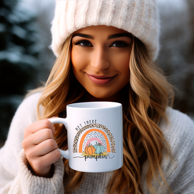 a woman wearing a white hat holding a white coffee mug