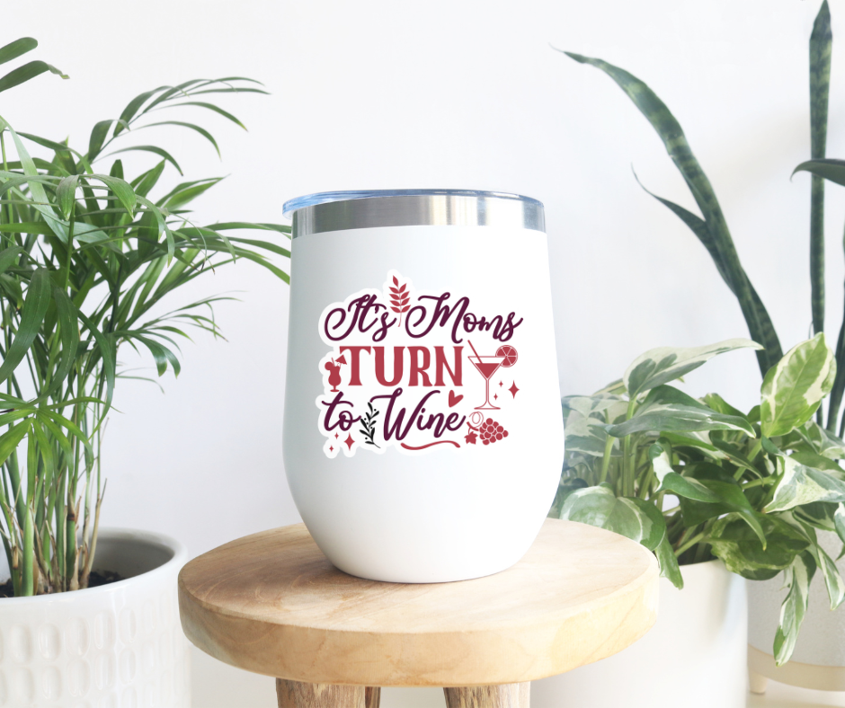 a white wine tumbler sitting on top of a wooden table