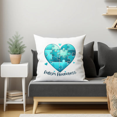 a heart shaped puzzle piece pillow on a couch