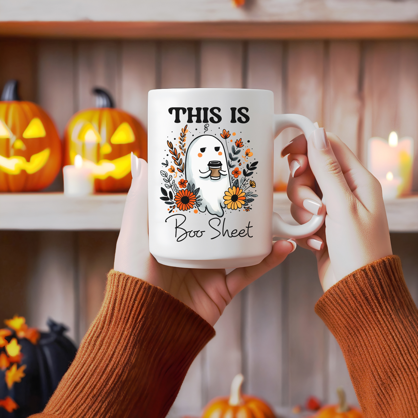 a person holding a coffee mug in front of a shelf with pumpkins