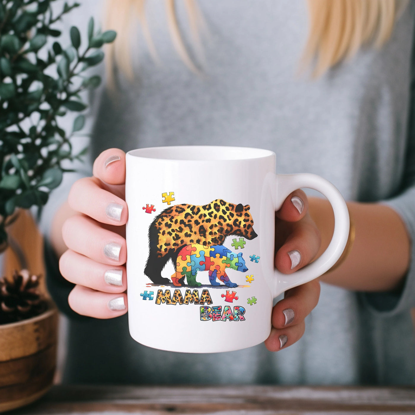 a woman holding a coffee mug with a bear on it