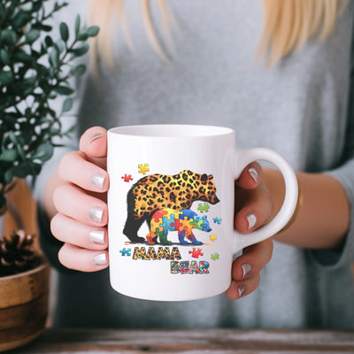 a woman holding a coffee mug with a bear on it