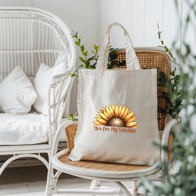 a white tote bag sitting on top of a chair