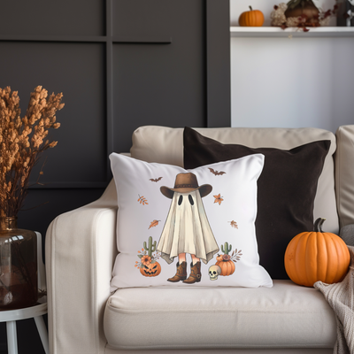 a white couch with a white pillow and some pumpkins