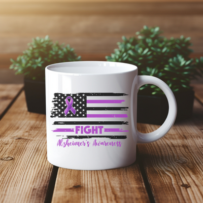 a white coffee mug with a purple ribbon on it