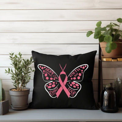 a black pillow with a pink butterfly on it