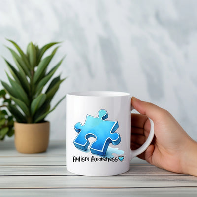 a person holding a coffee mug with a puzzle piece on it