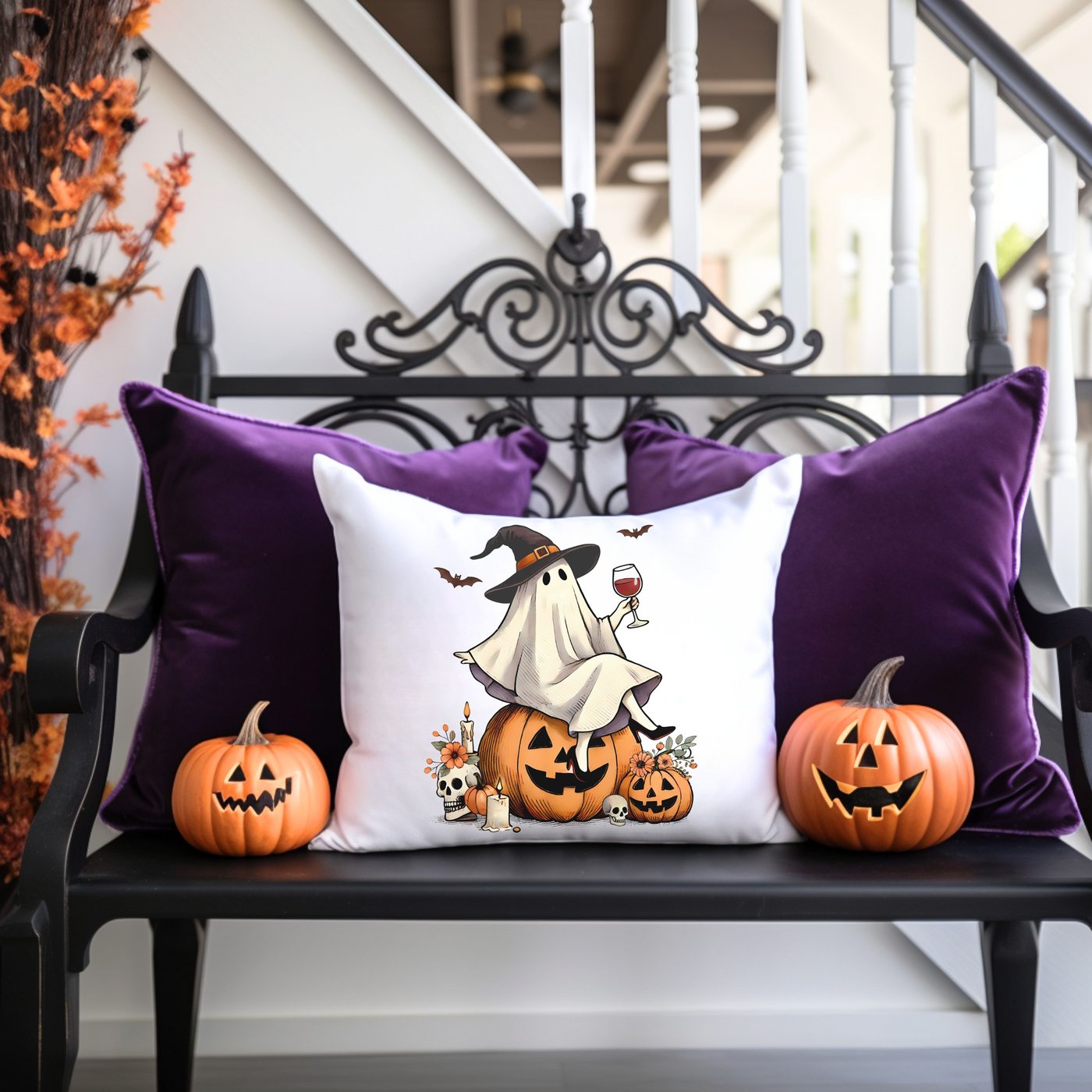 a bench with two pumpkins and a pillow on it