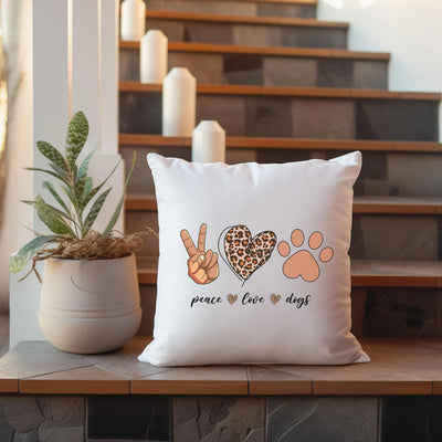 a pillow with a peace love and dogs design on it