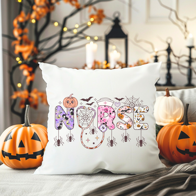 a pillow with the word boo on it next to pumpkins