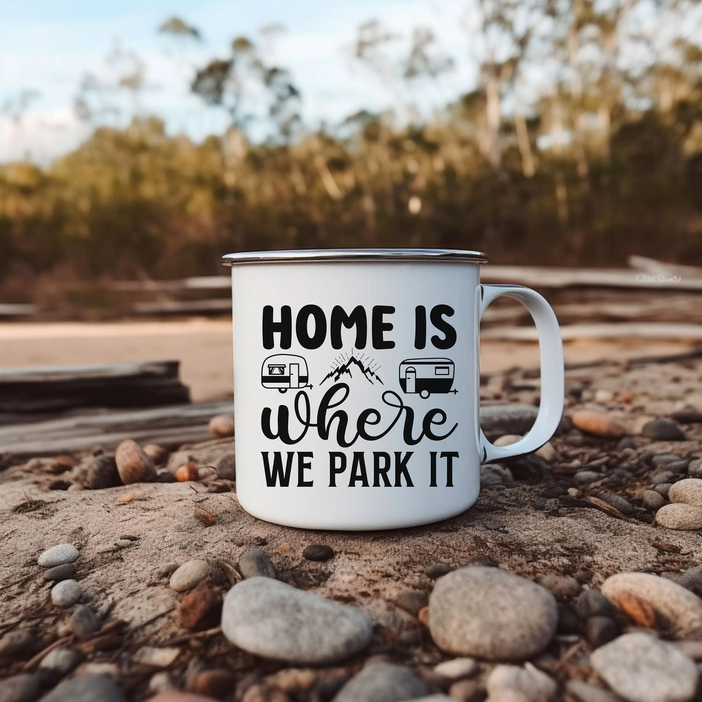 a camper mug sitting on the ground with the words home is where we park