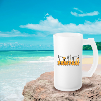 a white coffee mug sitting on top of a sandy beach