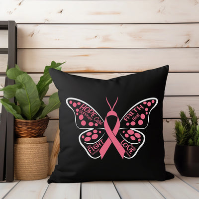 a black pillow with a pink butterfly on it