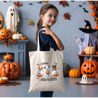 a little girl holding a trick - or - treat bag