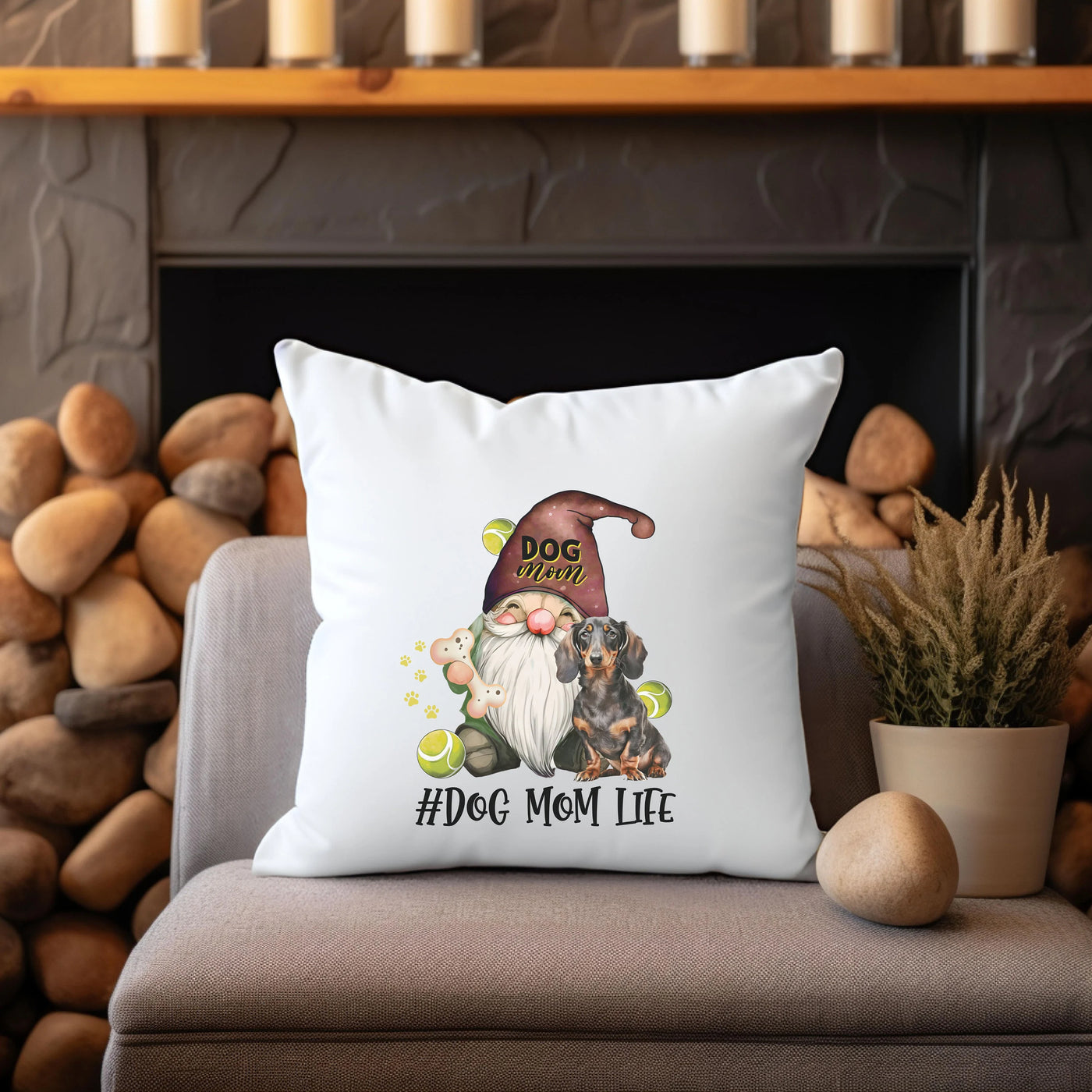 a pillow with a gnome on it sitting next to a potted plant