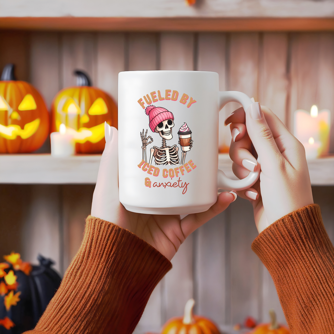 a person holding a coffee mug with a skeleton on it