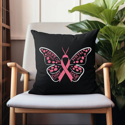 a black pillow with a pink butterfly on it