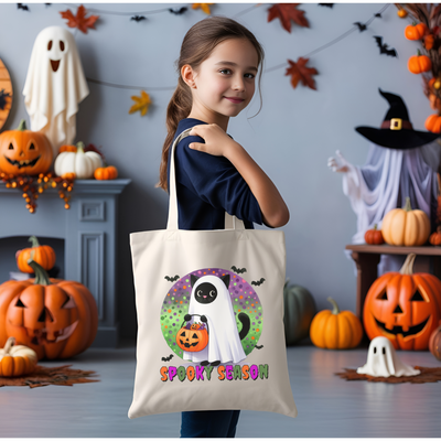 a little girl holding a trick or treat bag