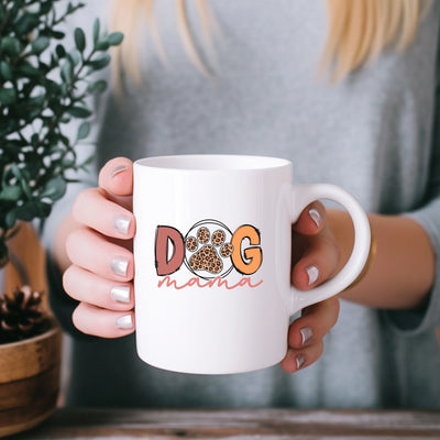 a woman holding a coffee mug with a dog design on it