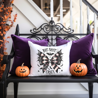 a bench with two pumpkins and a pillow on it