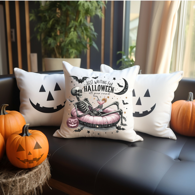 three pillows on a couch with pumpkins in the background