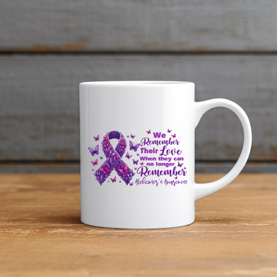 a white coffee mug with a purple ribbon on it