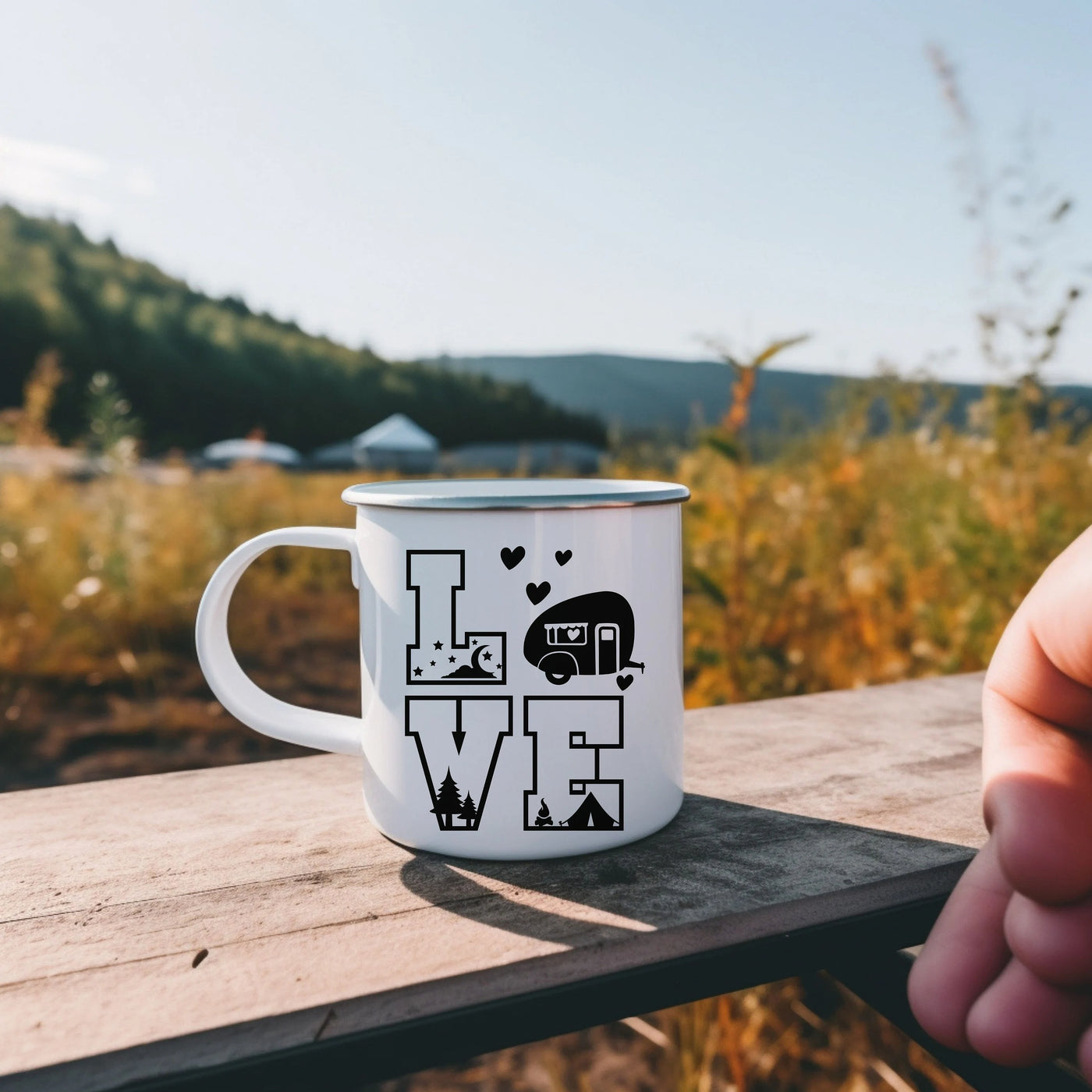 a person holding a coffee mug with the words love on it