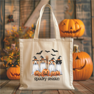 a tote bag with three ghostes and pumpkins on it