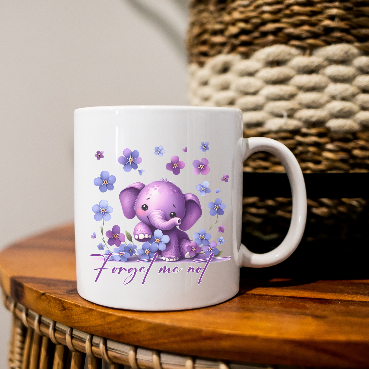 a white coffee mug with a purple elephant on it