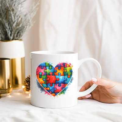 a person holding a coffee mug with a puzzle heart on it