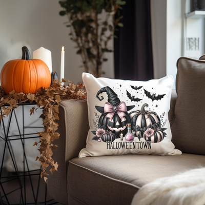 a halloween pillow sitting on top of a couch