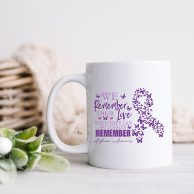 a white coffee mug with a purple ribbon on it