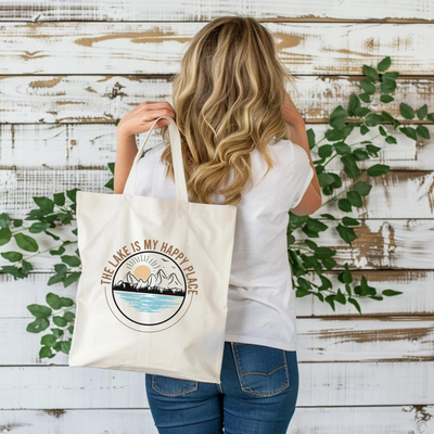 a woman holding a bag with a mountain scene on it