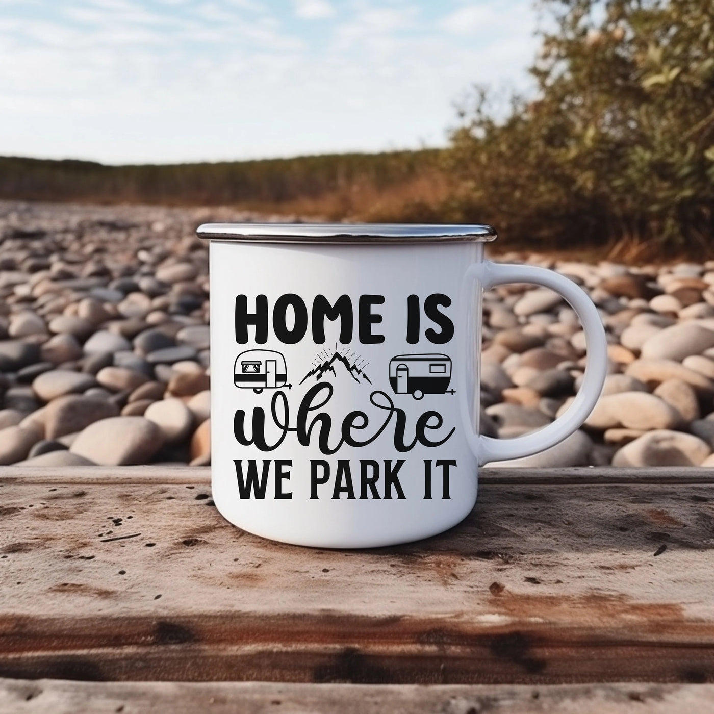 a white camper mug sitting on top of a wooden table