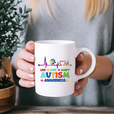 a woman holding a coffee mug with the words autism on it