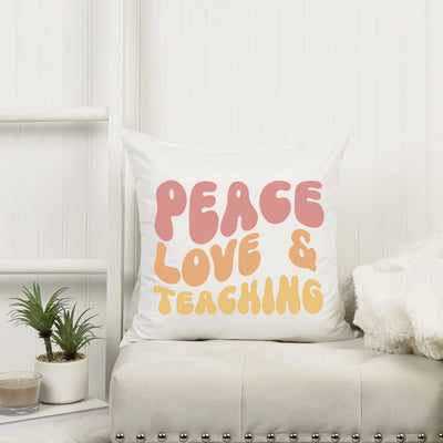 a white couch with a pillow that says peace love and teaching