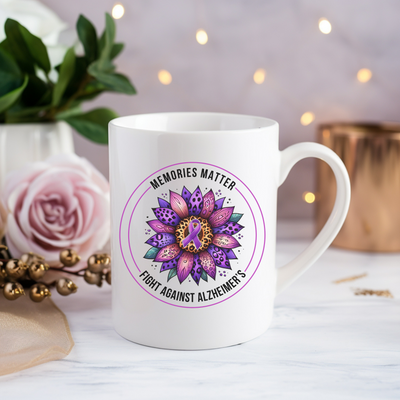 a white coffee mug with a pink flower on it