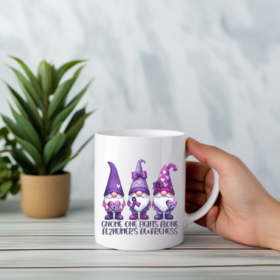 a person holding a coffee mug with three gnomes on it