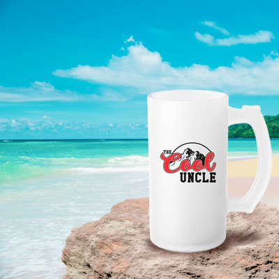 a white coffee mug sitting on top of a sandy beach