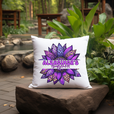 a white pillow with a purple flower on it