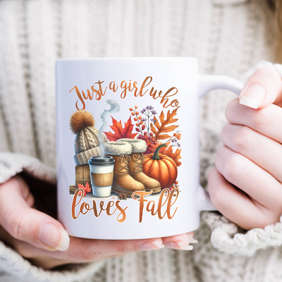 a woman is holding a coffee mug with autumn decorations