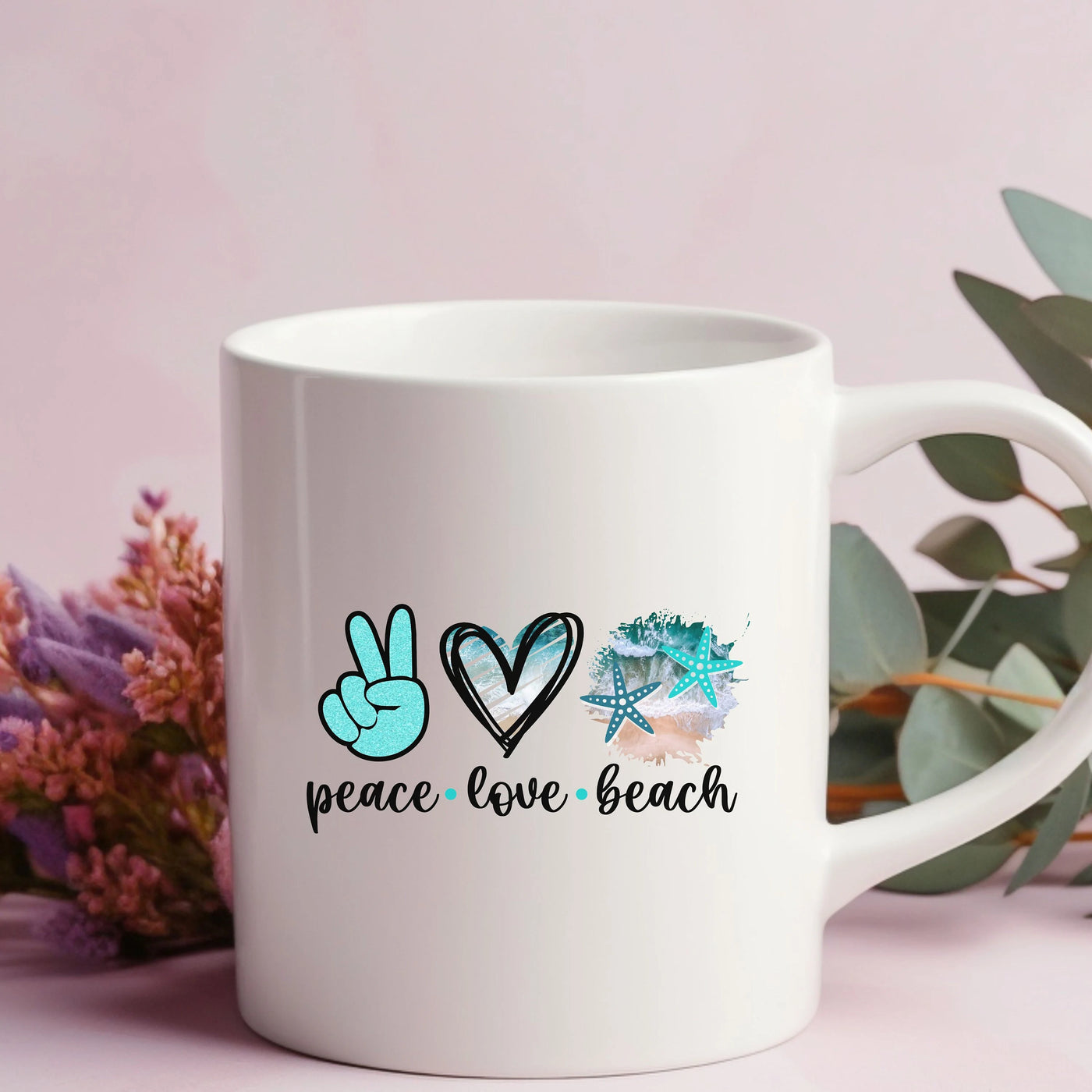 a white coffee mug with peace love beach written on it