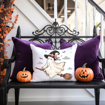 a bench with two pumpkins and a pillow on it