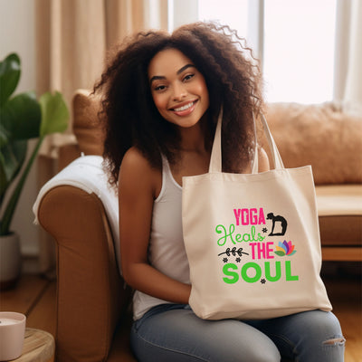 a woman sitting on a couch holding a yoga bag