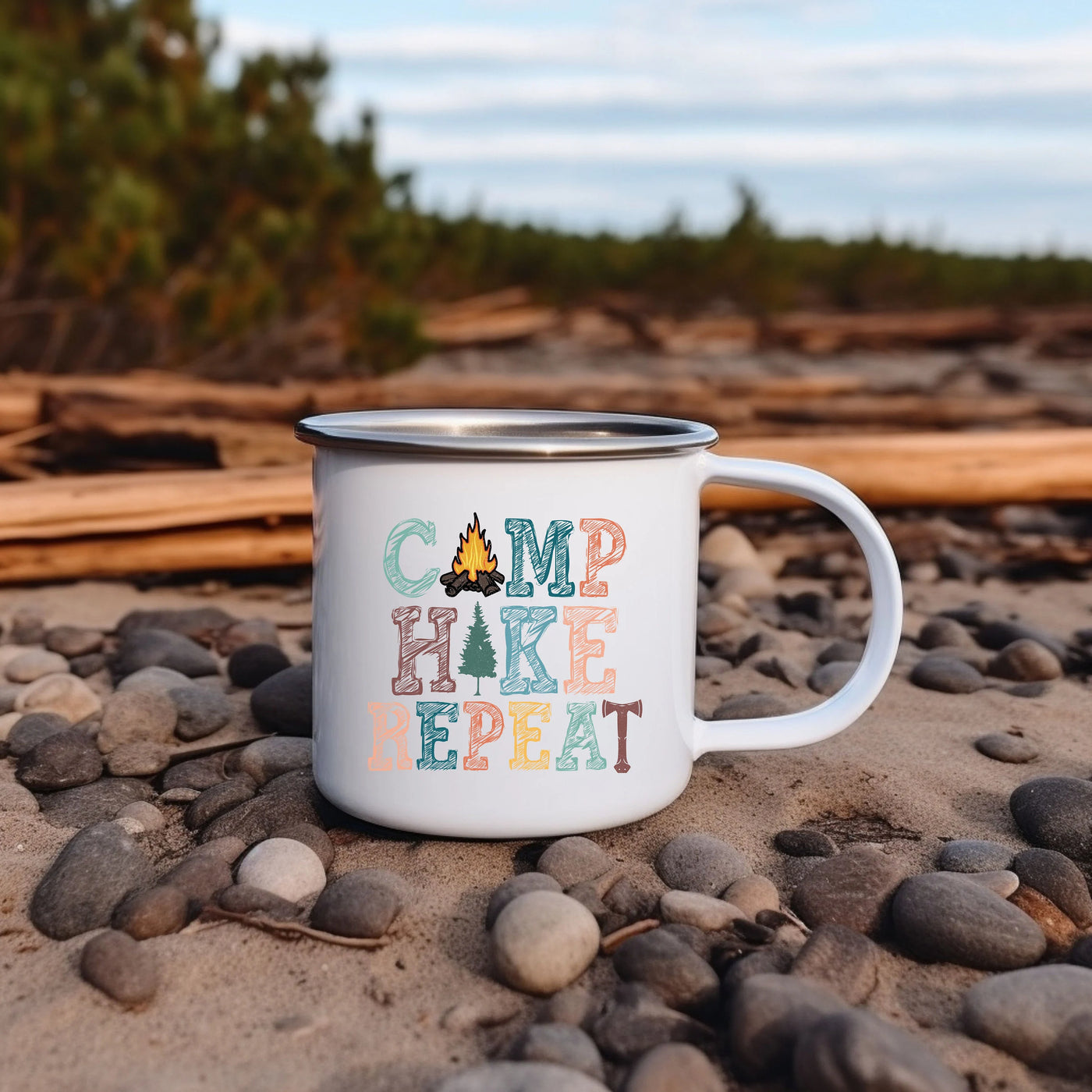 a camp mug sitting on a rocky beach